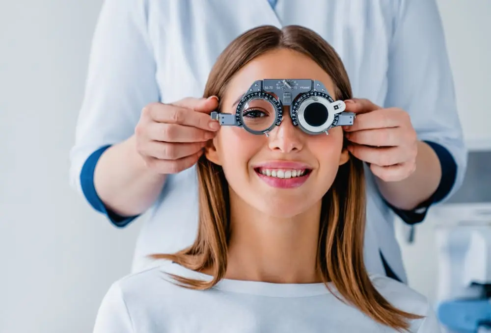 Woman undergoing an eye examination with a phoropter at Eye Care Clinic.